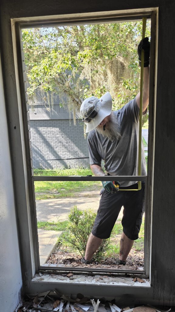 Breezy technician fitting new window glass